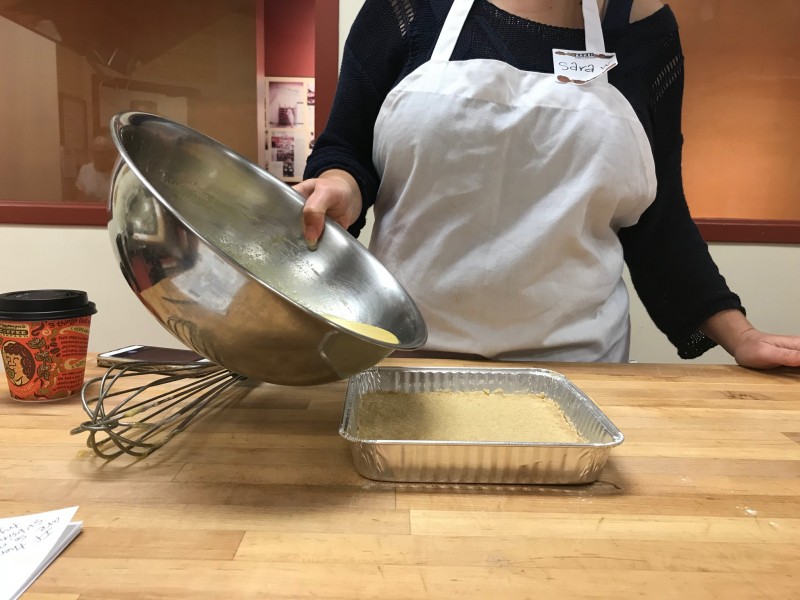 pouring liquid from a bowl into a pan