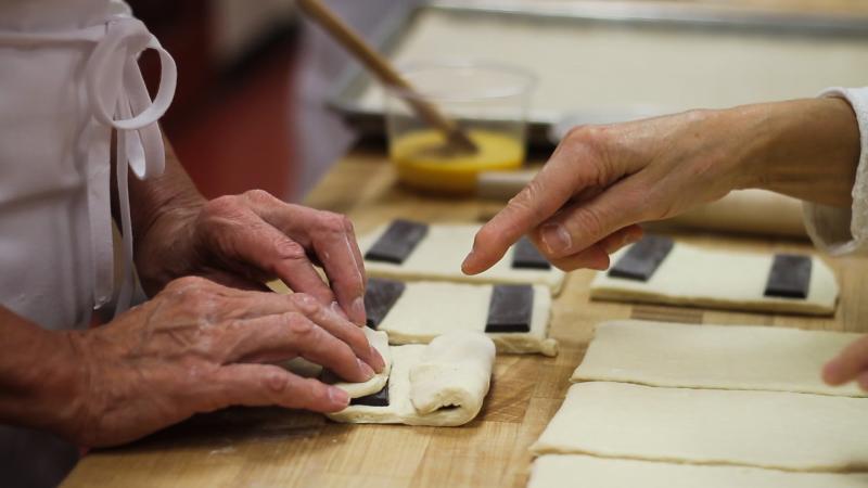hands making croissants