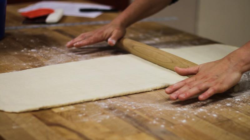 rolling dough with a rolling pin